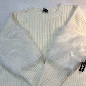 Cream sweater with fur accent on sleeves.